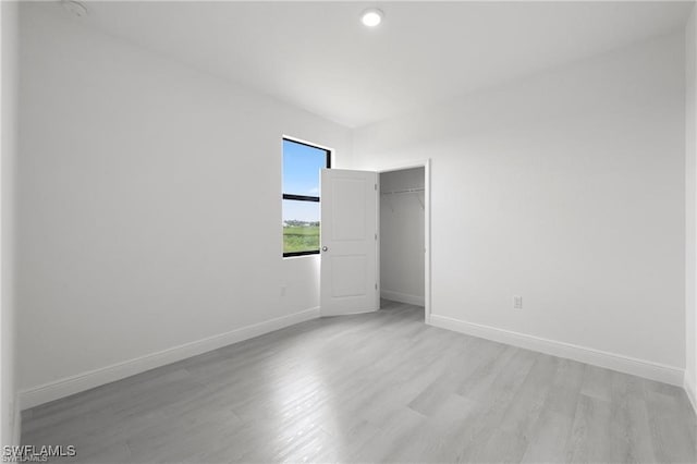 spare room featuring light hardwood / wood-style flooring