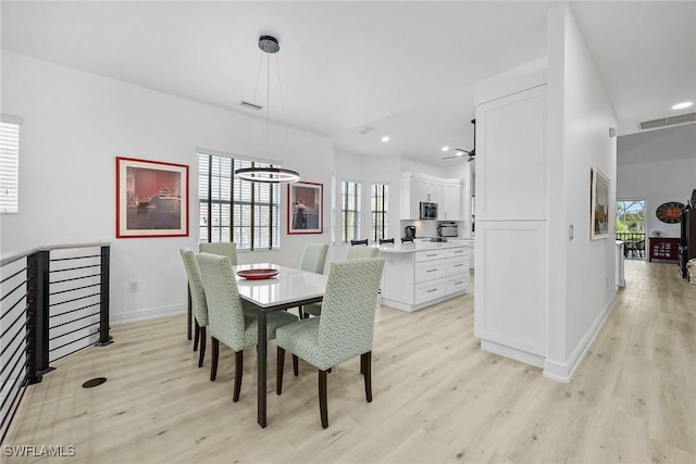 dining space featuring light wood-type flooring