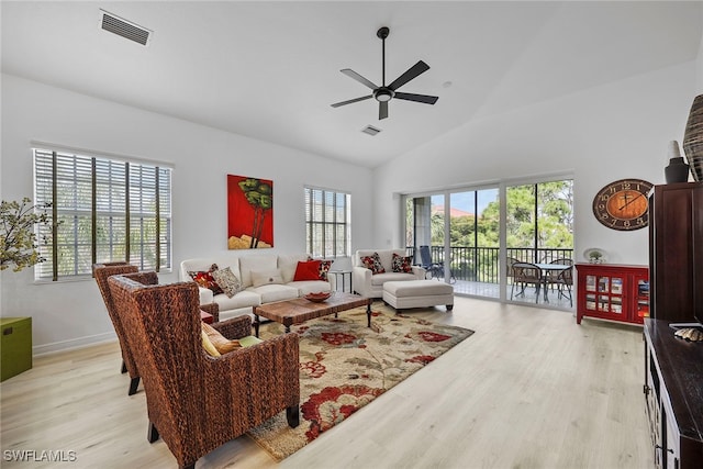 living room featuring light hardwood / wood-style flooring, high vaulted ceiling, and ceiling fan