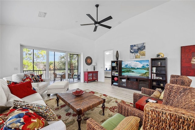 living room with light hardwood / wood-style flooring, high vaulted ceiling, and ceiling fan