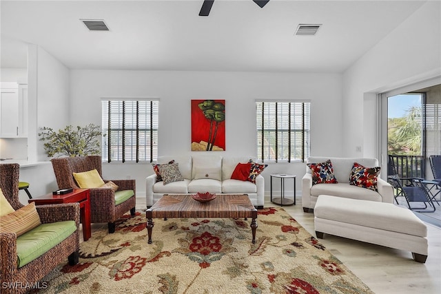 living room featuring ceiling fan, a healthy amount of sunlight, and light hardwood / wood-style floors