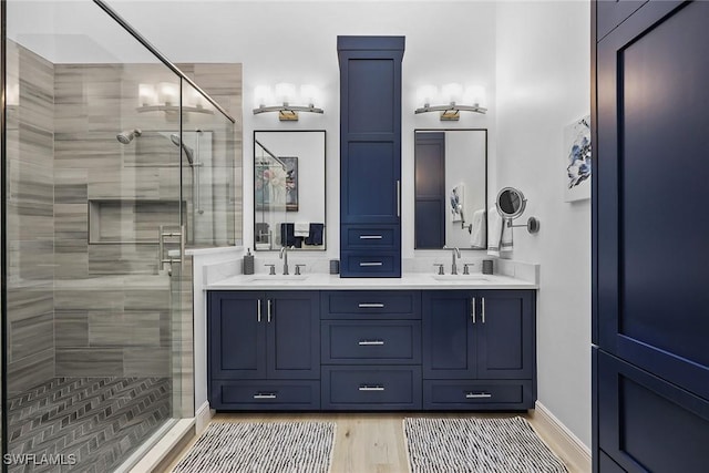 bathroom with vanity and a shower with shower door