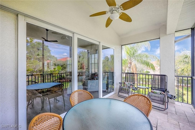 sunroom / solarium featuring a wealth of natural light and ceiling fan