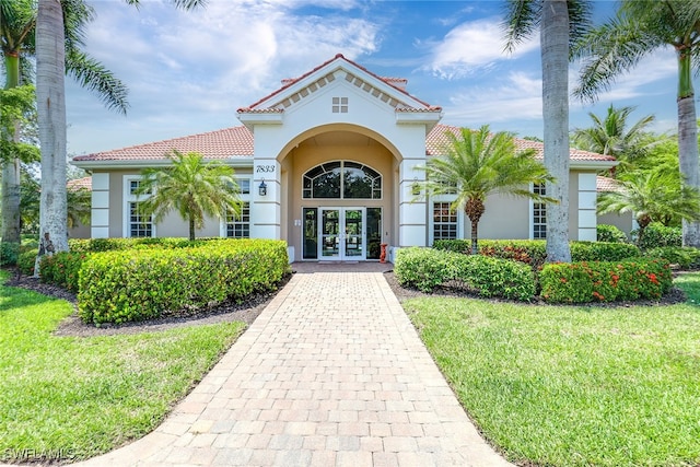 property entrance with french doors and a yard