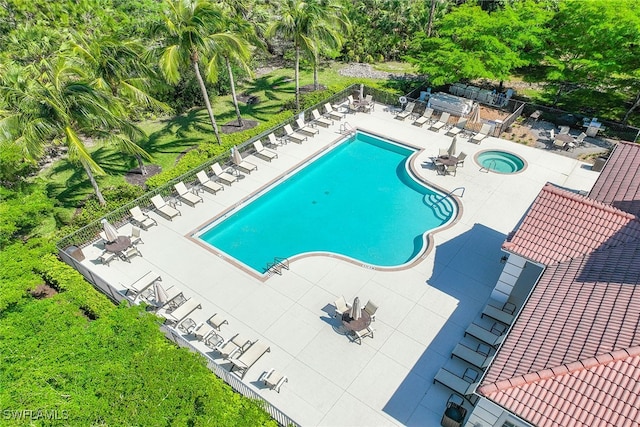 view of pool featuring a community hot tub and a patio