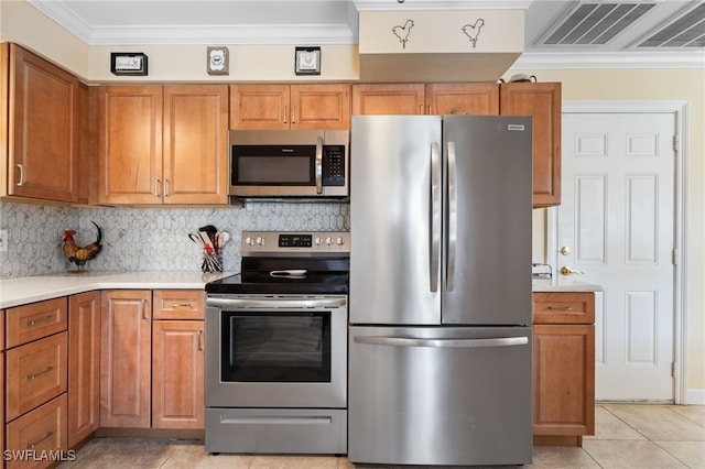 kitchen with decorative backsplash, crown molding, light tile patterned floors, and stainless steel appliances