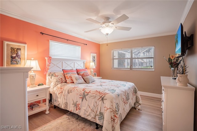 bedroom with multiple windows, ceiling fan, crown molding, and wood-type flooring