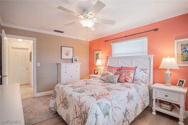 bedroom featuring ceiling fan, light wood-type flooring, and crown molding