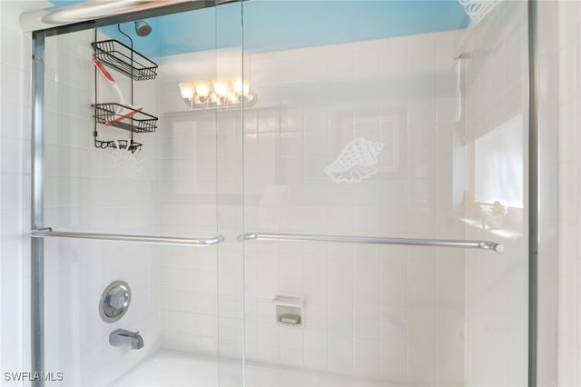 bathroom featuring shower / bath combination with glass door