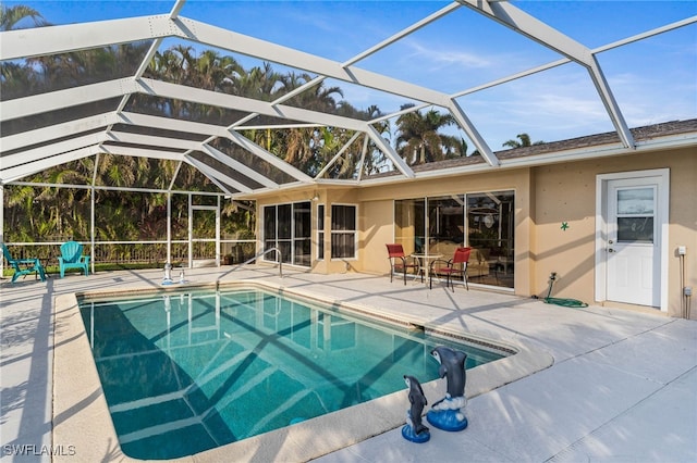 view of swimming pool with a patio area and a lanai