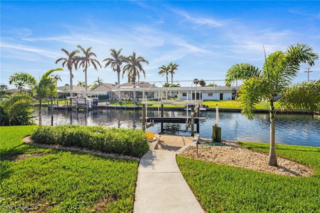 dock area with a yard and a water view