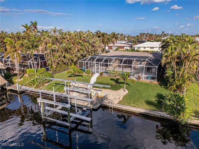 dock area with a lanai, a yard, and a water view