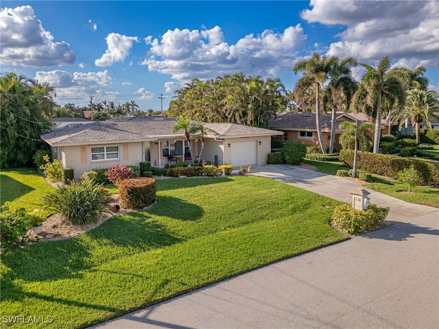 ranch-style house featuring a front yard and a garage