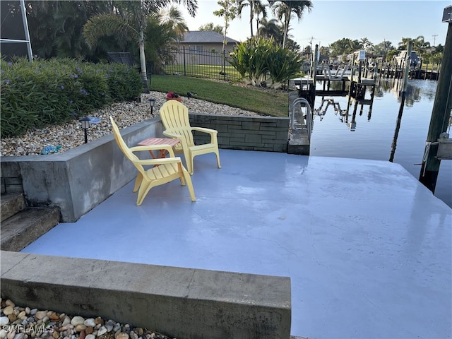 view of patio / terrace featuring a dock and a water view