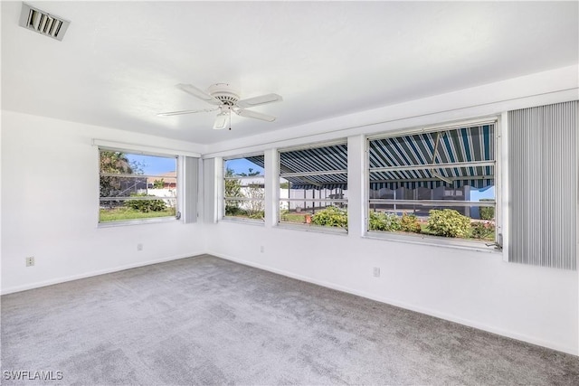 carpeted spare room with ceiling fan