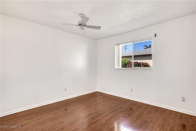 empty room with ceiling fan, wood-type flooring, and a textured ceiling