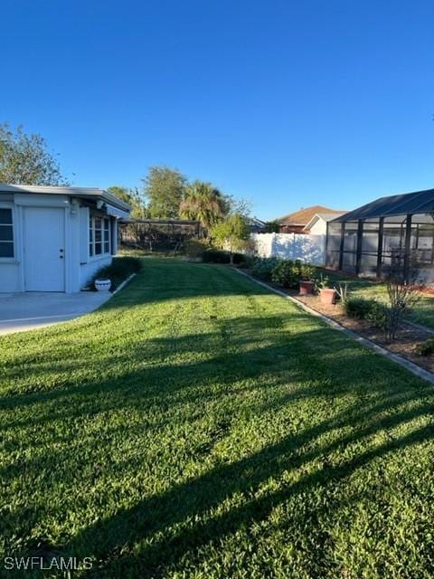 view of yard with a lanai and a patio