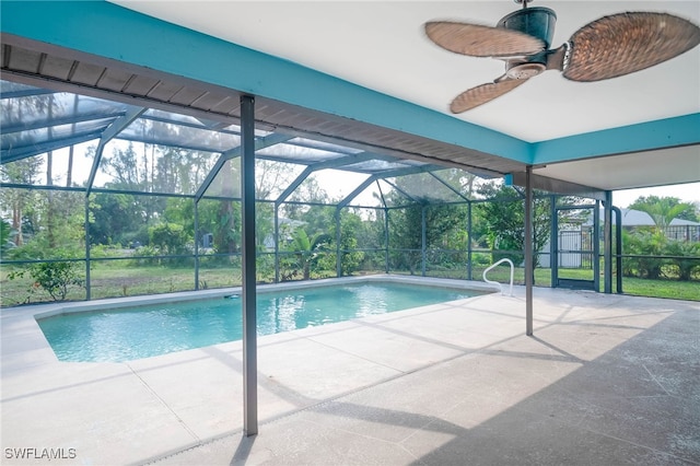 view of swimming pool featuring ceiling fan, a patio area, and a lanai