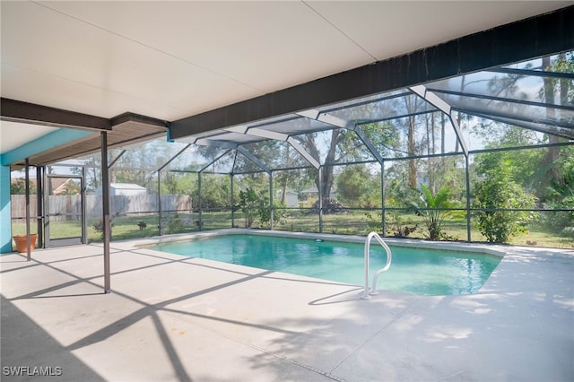 view of swimming pool featuring a patio and glass enclosure