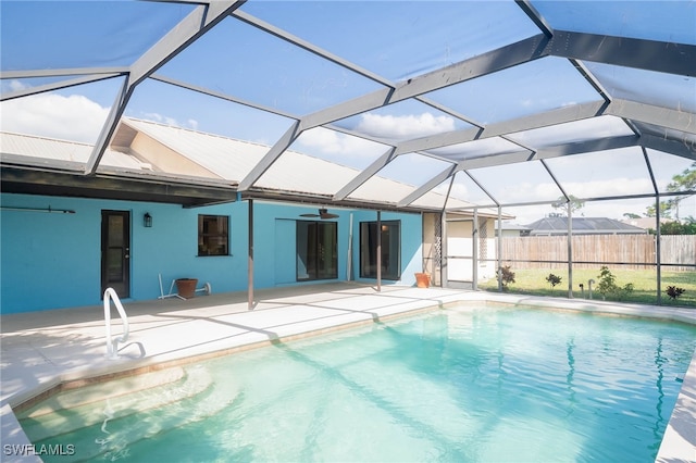 view of pool with a lanai, ceiling fan, and a patio area