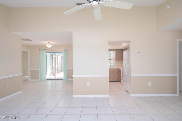 tiled spare room featuring ceiling fan