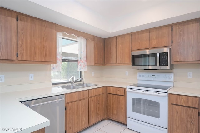 kitchen with light tile patterned floors, sink, and appliances with stainless steel finishes