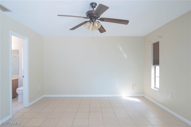 tiled empty room featuring ceiling fan