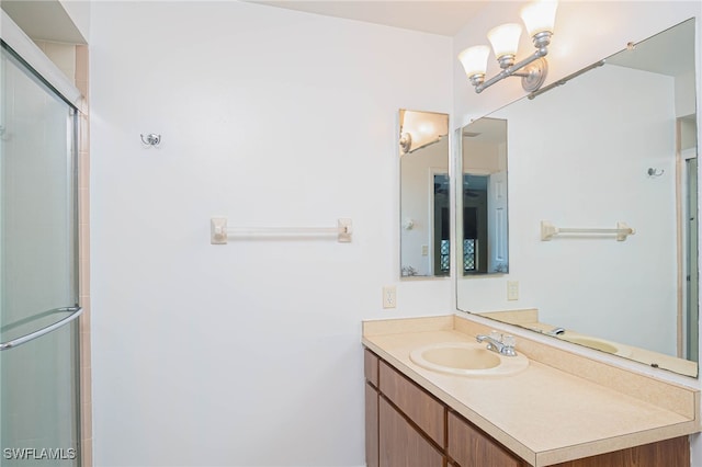 bathroom featuring vanity and an enclosed shower