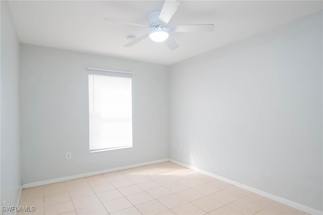 unfurnished room featuring ceiling fan, plenty of natural light, and light tile patterned floors