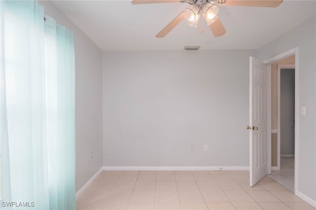 tiled empty room with ceiling fan