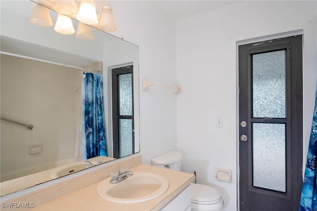 bathroom featuring vanity, toilet, walk in shower, and a wealth of natural light