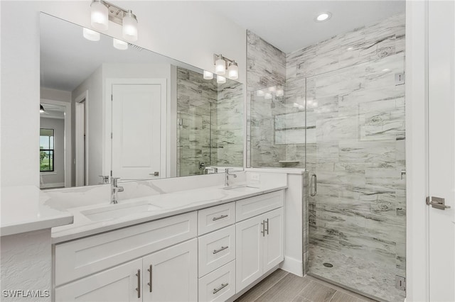 bathroom featuring vanity, an enclosed shower, and wood-type flooring