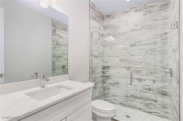 bathroom with vanity, toilet, and a shower with shower door