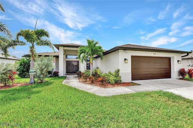 view of front of home featuring a front yard and a garage