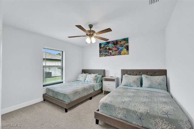 bedroom featuring ceiling fan and carpet