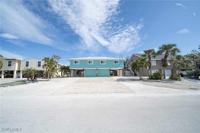 21671/21673 Indian Bayou Dr, Fort Myers Beach, FL 33931 - view of front of home featuring a carport, gravel driveway, and a residential view
