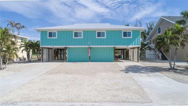 raised beach house featuring a carport