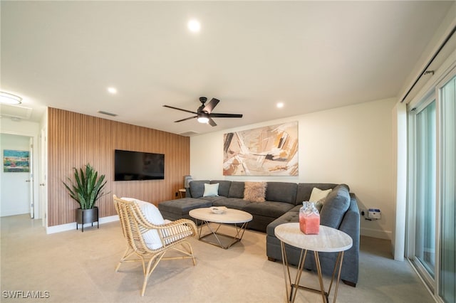 carpeted living room featuring ceiling fan