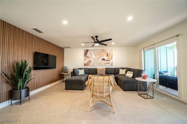 carpeted living room featuring ceiling fan