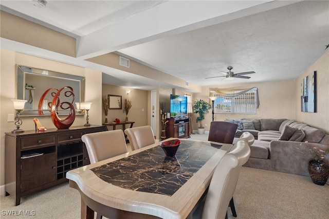 dining area with light carpet and ceiling fan