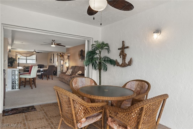 dining area with carpet flooring and ceiling fan