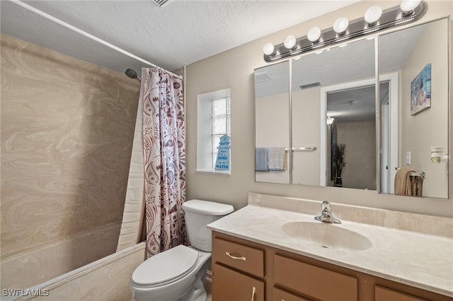 full bathroom with vanity, toilet, shower / bath combo with shower curtain, and a textured ceiling