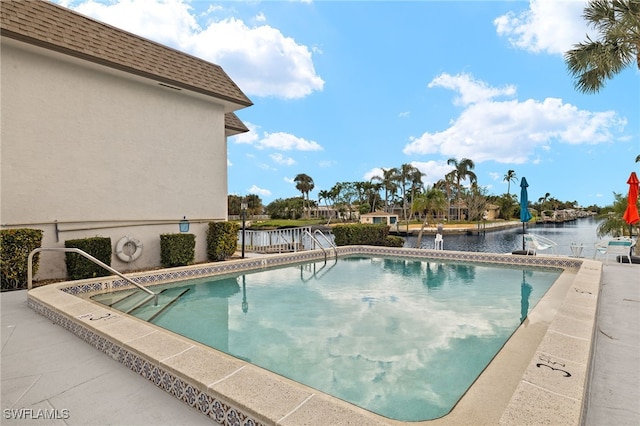 view of swimming pool featuring a water view