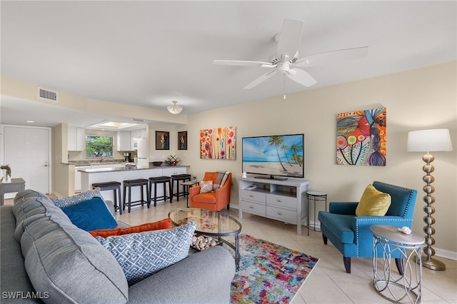 living room with light tile patterned floors and ceiling fan