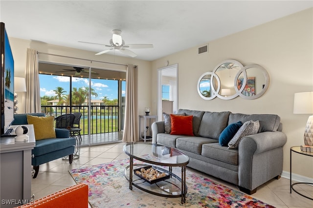 tiled living room with ceiling fan