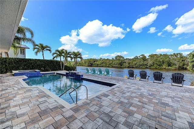 view of pool with an in ground hot tub, a water view, and a patio area