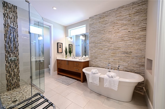 full bathroom with tile patterned floors, vanity, toilet, and plus walk in shower