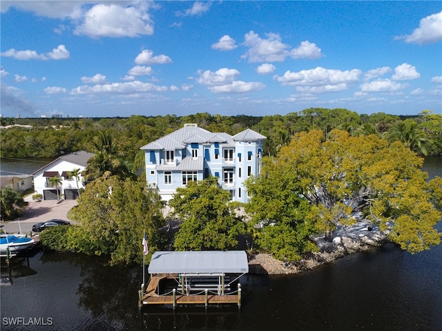 birds eye view of property with a water view