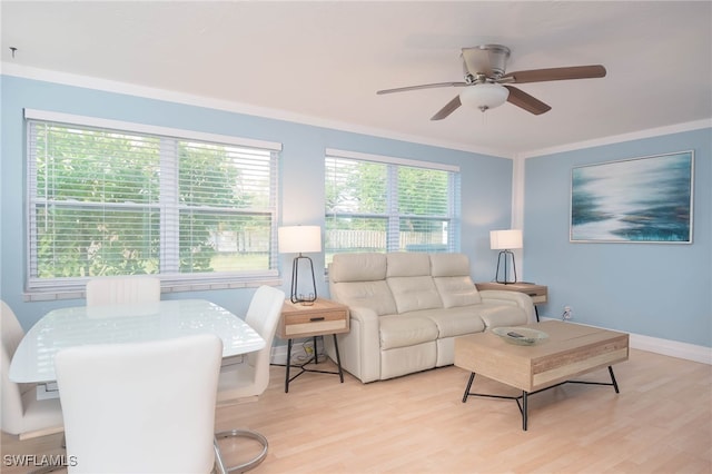 living room with light wood-type flooring, ceiling fan, and crown molding