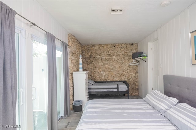 bedroom with wooden walls